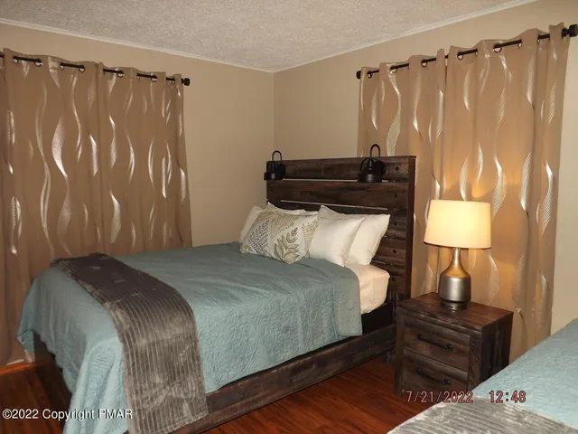 a bedroom with a bed and a night stand