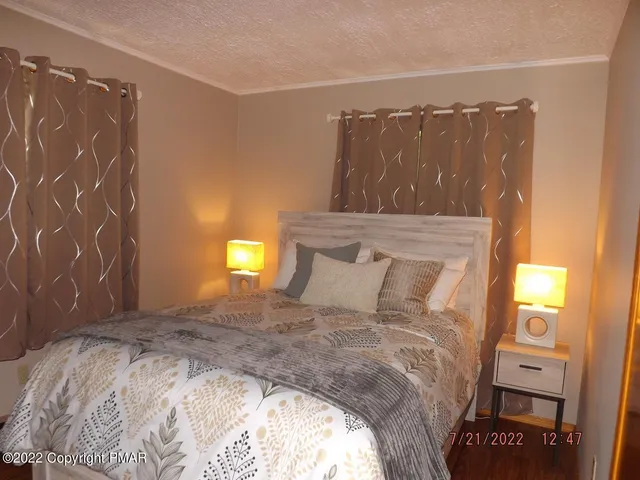 a large bed sitting in a bedroom next to a window