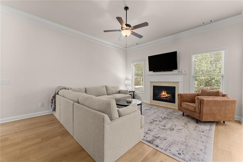 8055 Veranda Curve Ball Ground, GA 30107 - Photo 16 of 65 a living room with furniture a flat screen tv and a fireplace