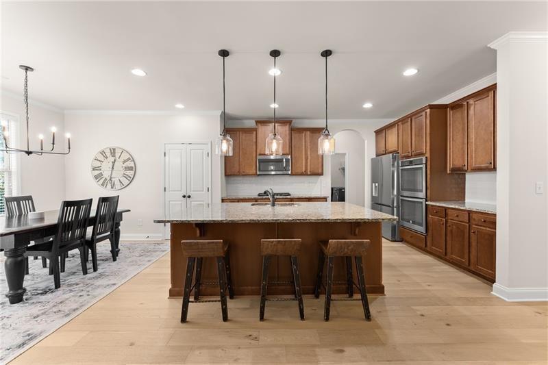 8055 Veranda Curve Ball Ground, GA 30107 - Photo 18 of 65 a large kitchen with a table and chairs