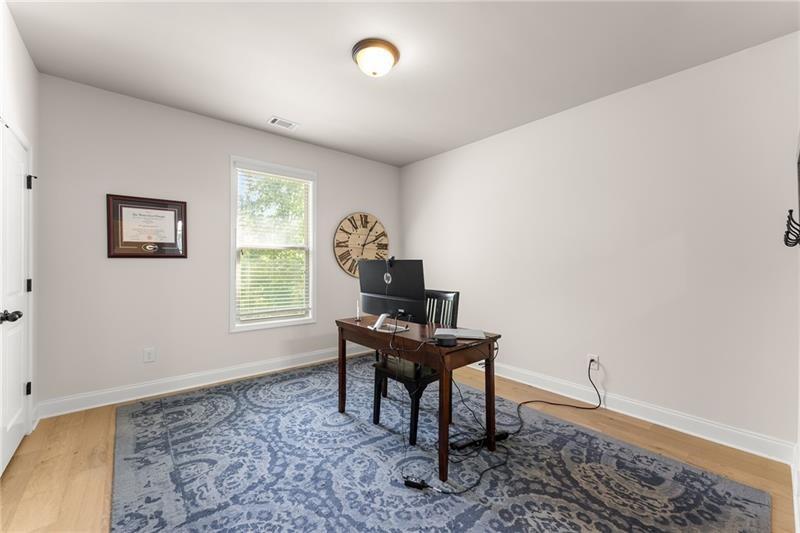 8055 Veranda Curve Ball Ground, GA 30107 - Photo 25 of 65 a view of a workspace with furniture and a window