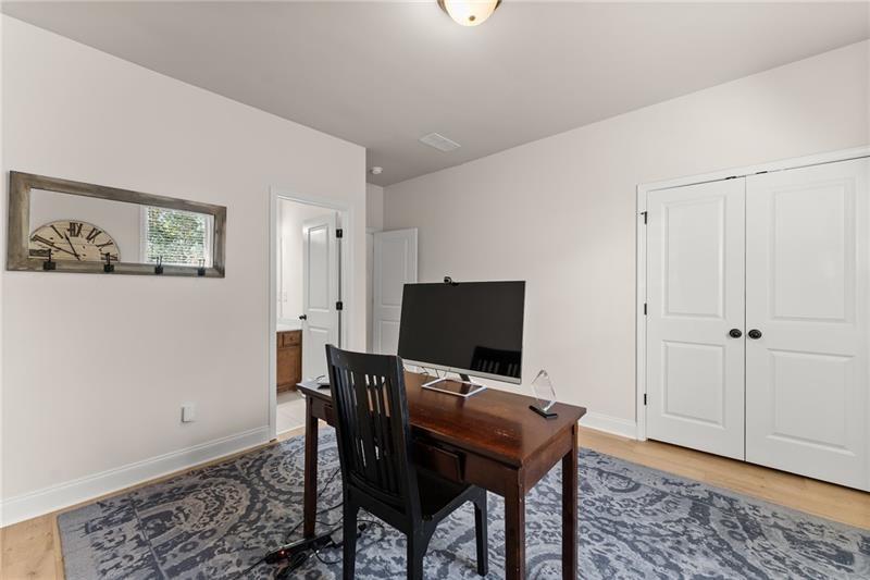 8055 Veranda Curve Ball Ground, GA 30107 - Photo 26 of 65 a view of a workspace with furniture and wooden floor