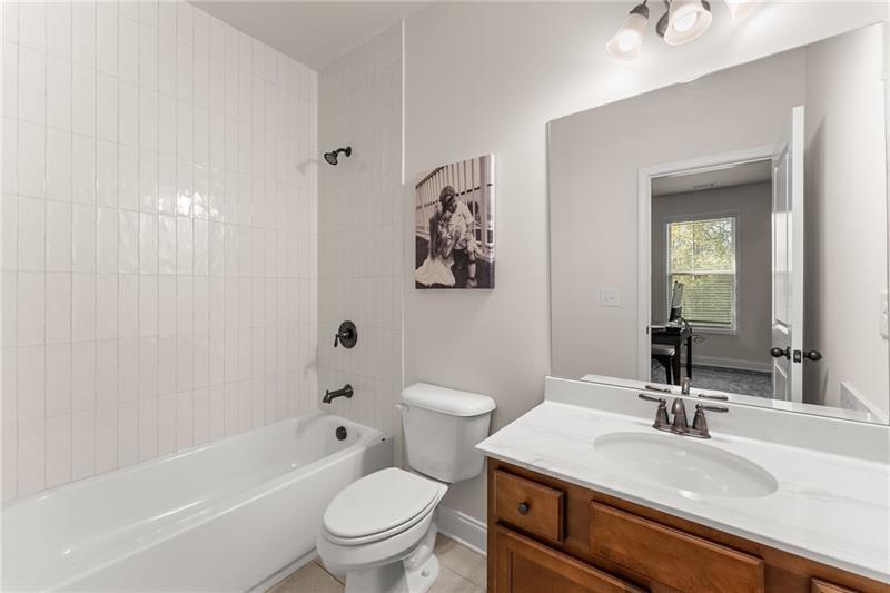 8055 Veranda Curve Ball Ground, GA 30107 - Photo 27 of 65 a bathroom with a sink a toilet and shower