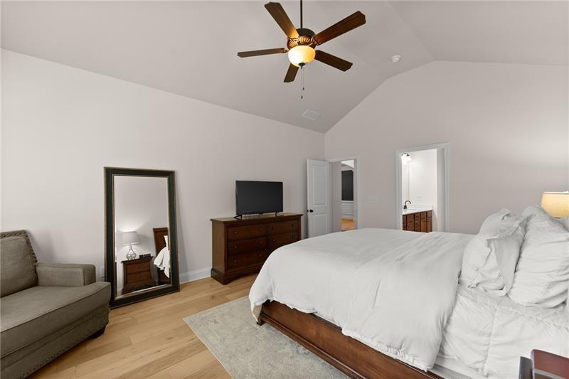 8055 Veranda Curve Ball Ground, GA 30107 - Photo 31 of 65 a bedroom with a bed and a couch