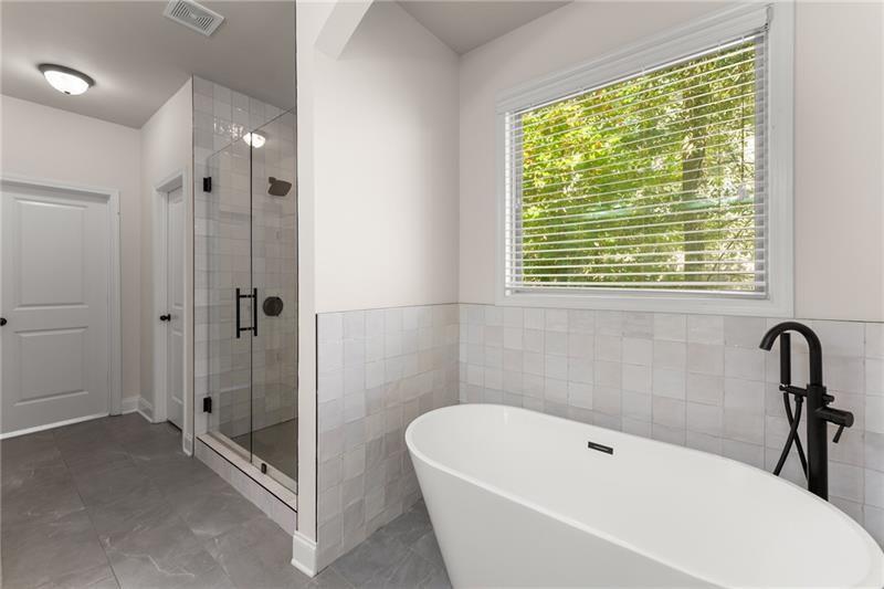 8055 Veranda Curve Ball Ground, GA 30107 - Photo 5 of 65 a bathroom with a tub a sink and a shower