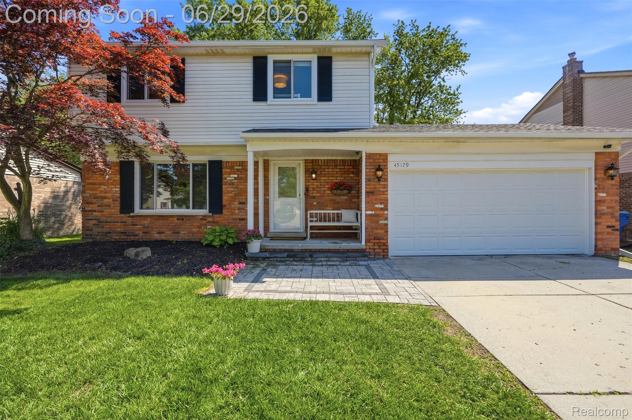 45179 Rudgate Road Canton, MI 48188 - Photo 2 of 48 Two-story residence featuring brick and siding exterior, an attached two-car garage, and a covered front porch