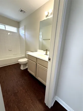 a bathroom with a toilet a sink and a mirror