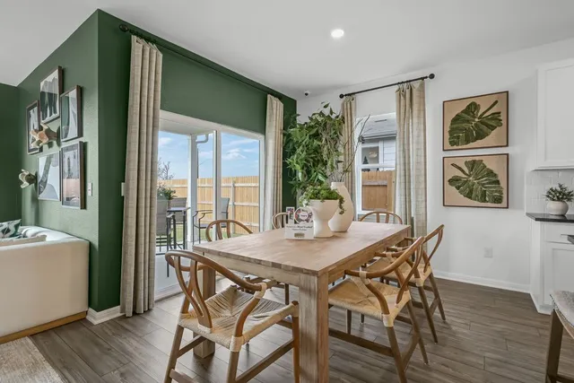 a living room with furniture and view of kitchen