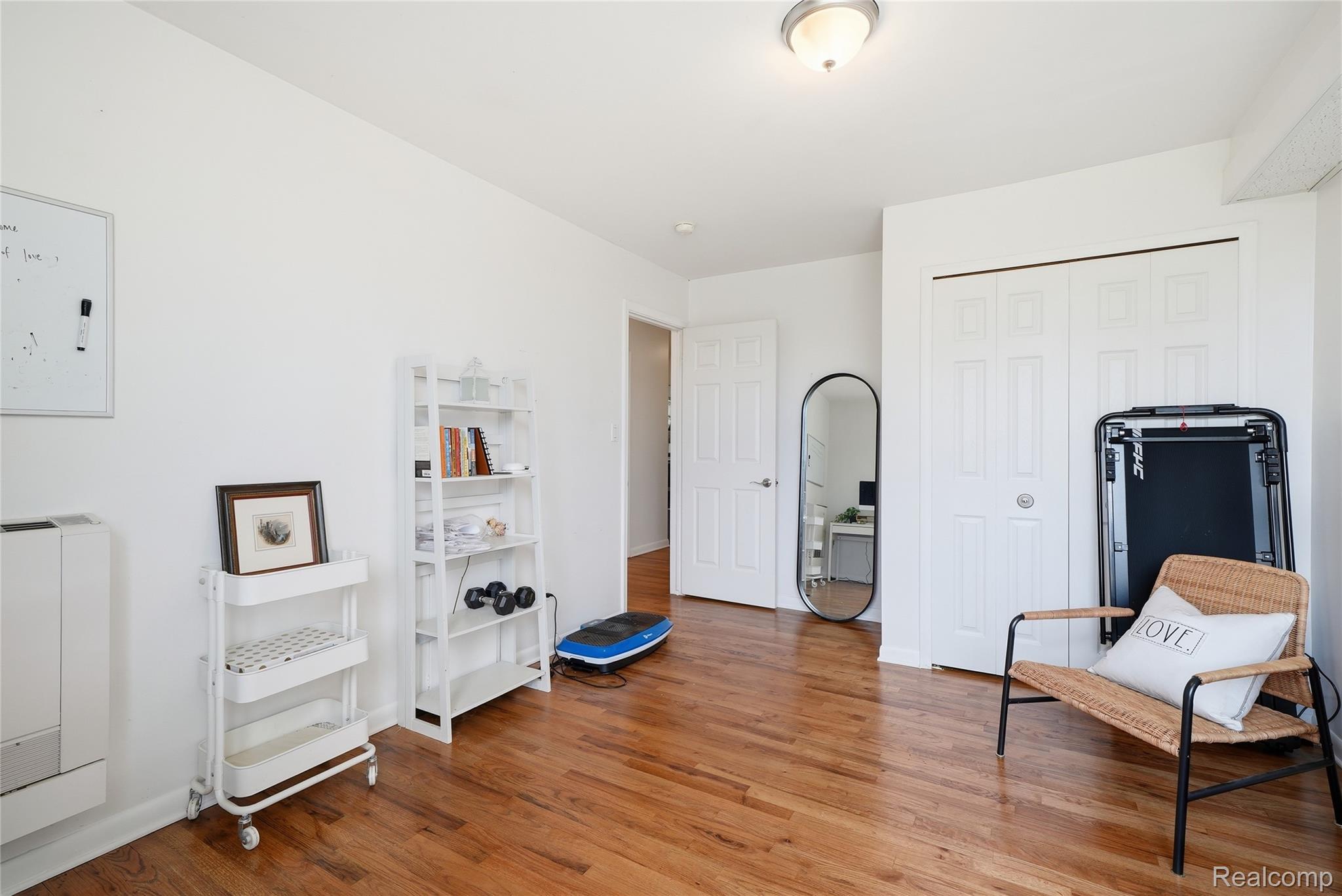 4041 West Maple Road, Unit E203 Bloomfield Hills, MI 48301 - Photo 20 of 25 Living area with light wood-style floors and baseboards