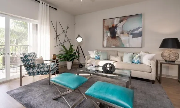 a living room with furniture and a large window