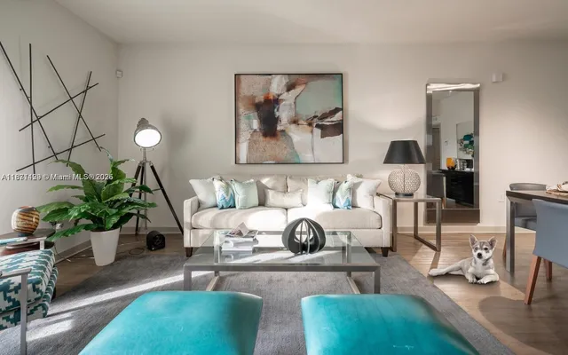 a living room with furniture and a potted plant