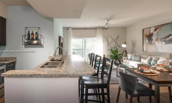 a dining room with kitchen island granite countertop furniture a chandelier and kitchen view