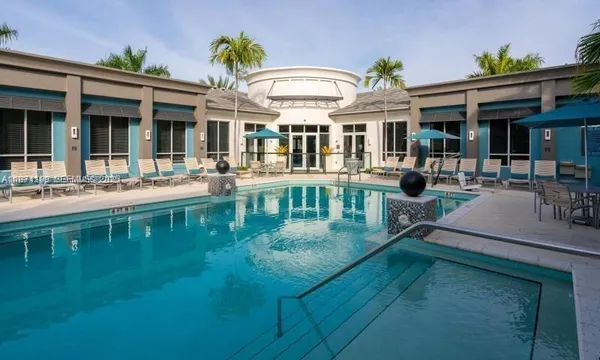 a view of a house with a swimming pool and porch