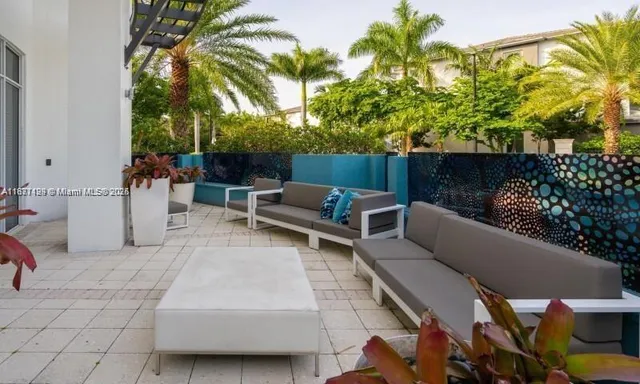 a view of a patio with couches and a potted plant on a table