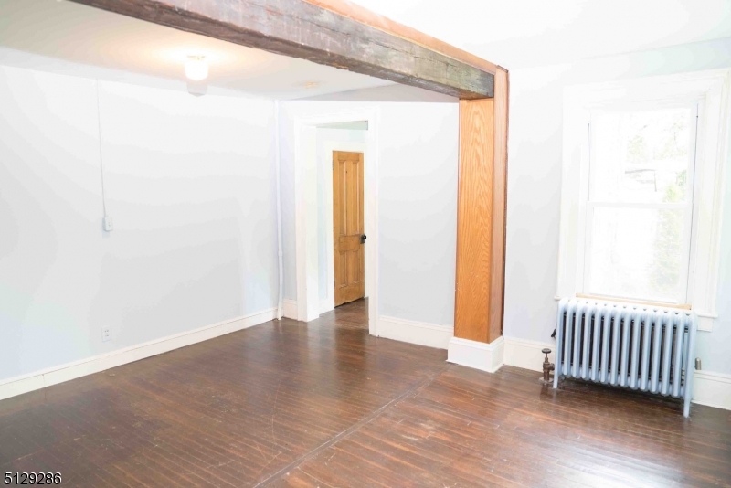 168 East Main Street Lebanon, NJ 08833 - Photo 12 of 33 an empty room with wooden floor and a window