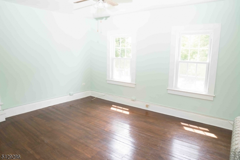 168 East Main Street Lebanon, NJ 08833 - Photo 20 of 33 an empty room with wooden floor and windows