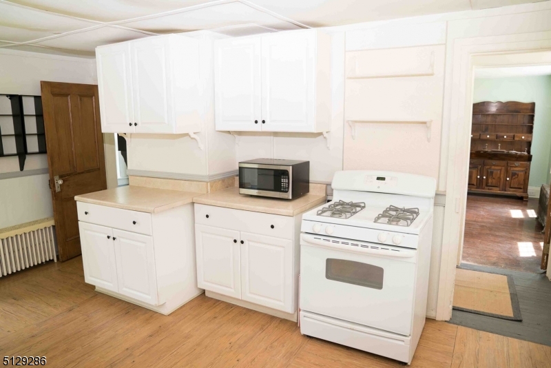 168 East Main Street Lebanon, NJ 08833 - Photo 28 of 33 a kitchen with white cabinets and white appliances