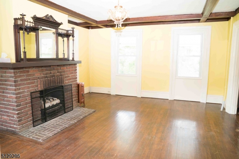 168 East Main Street Lebanon, NJ 08833 - Photo 9 of 33 a view of empty room with a fireplace and wooden floor