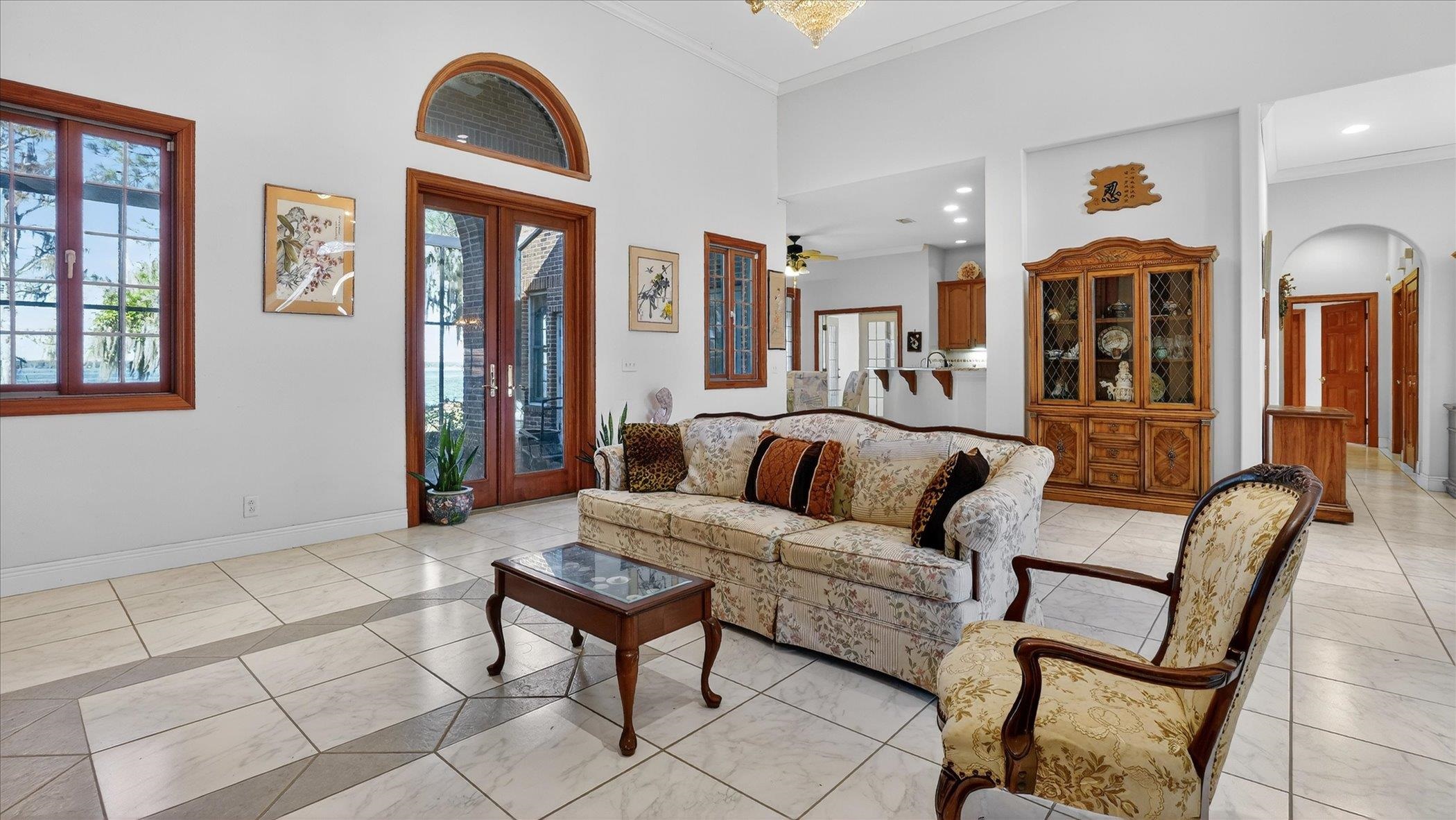 453 Federal Point Road East Palatka, FL 32131 - Photo 10 of 68 a living room with furniture and floor to ceiling windows