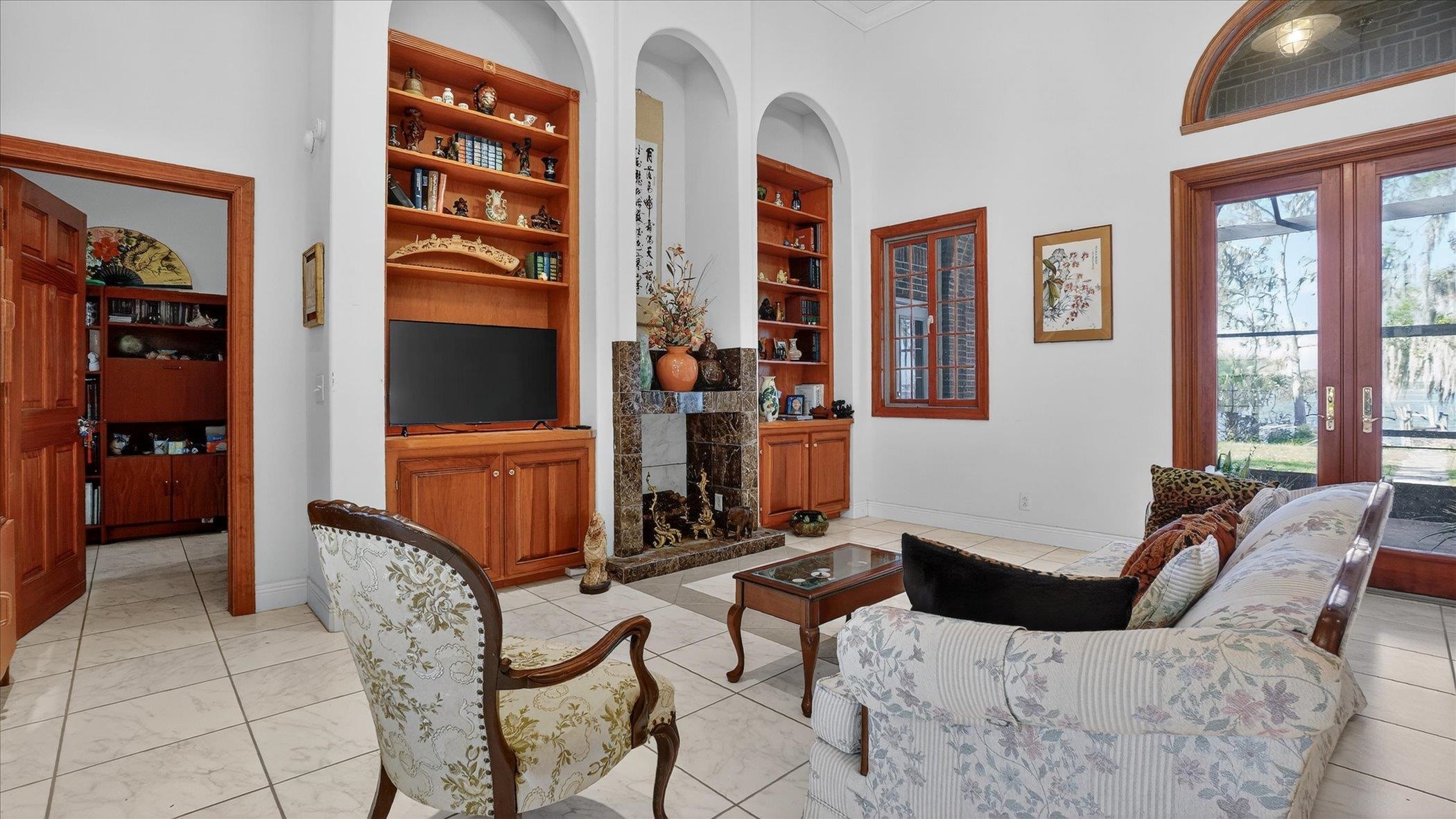 453 Federal Point Road East Palatka, FL 32131 - Photo 12 of 68 a living room with furniture a lamp and large window
