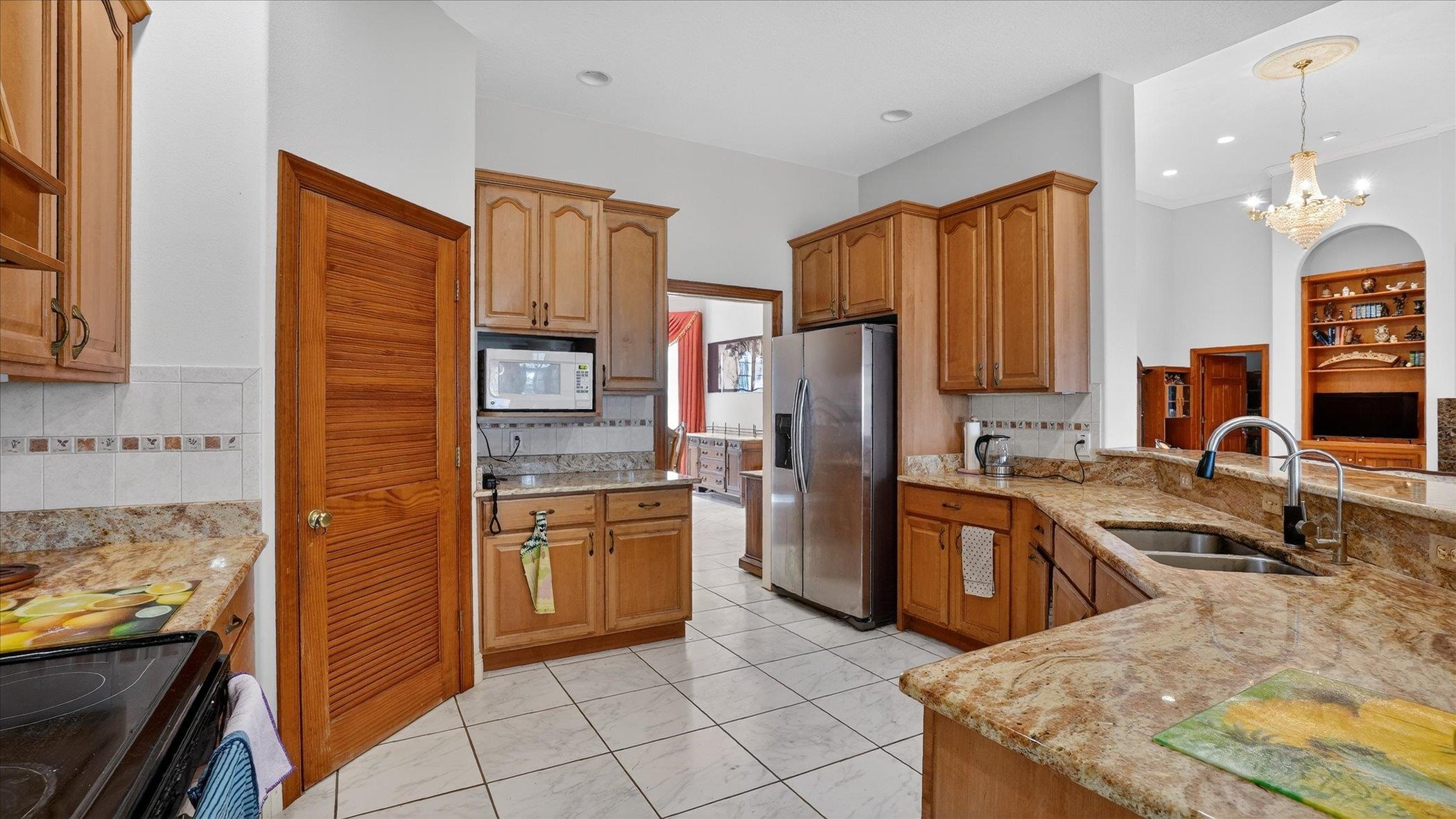 453 Federal Point Road East Palatka, FL 32131 - Photo 14 of 68 a kitchen with stainless steel appliances granite countertop a refrigerator stove and sink