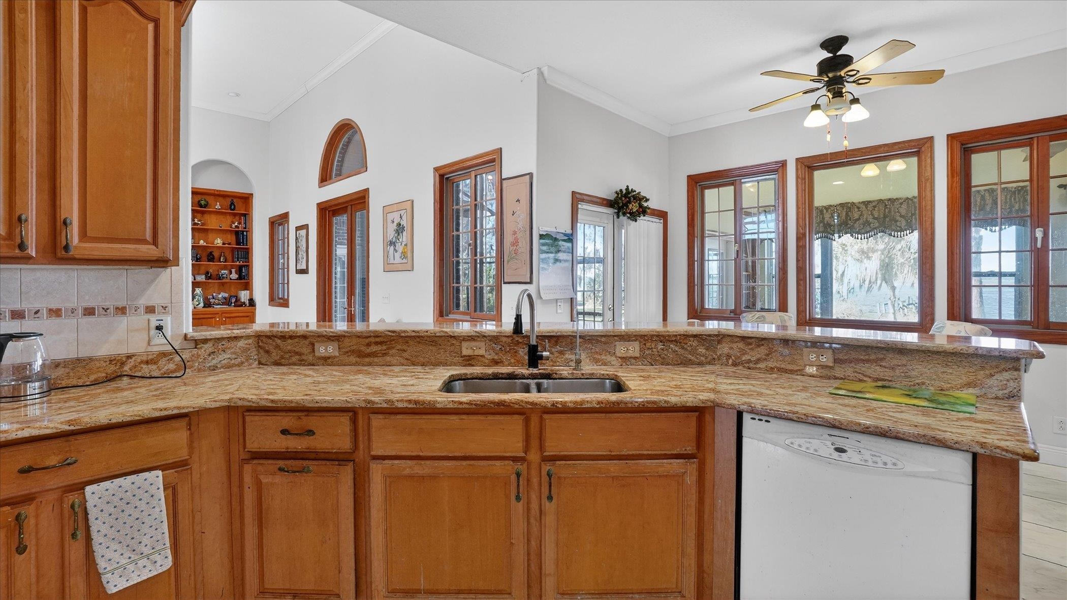 453 Federal Point Road East Palatka, FL 32131 - Photo 17 of 68 a kitchen with a granite countertop a sink and a window