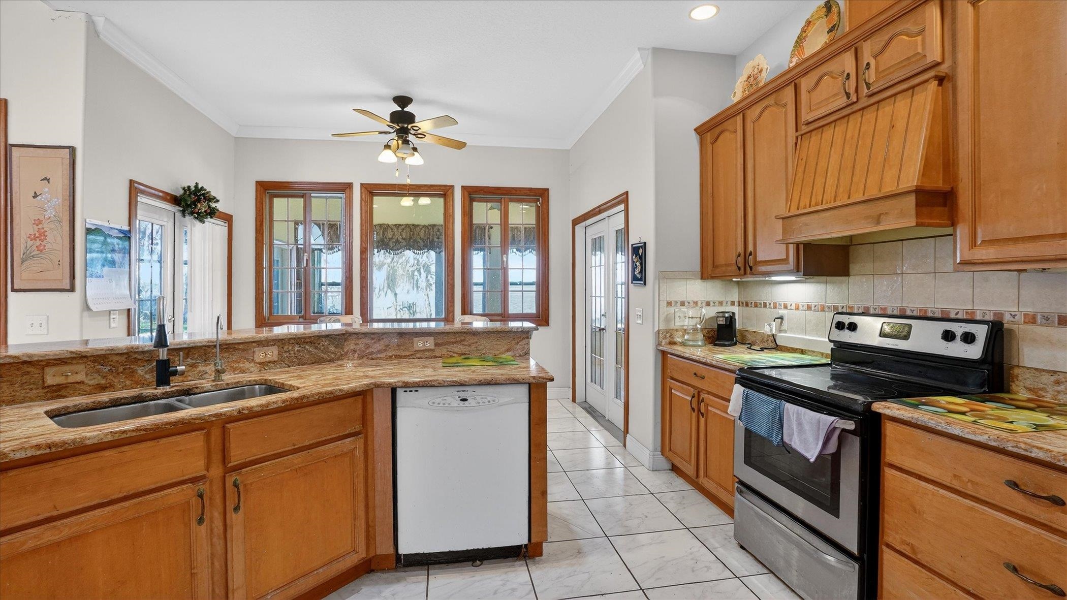 453 Federal Point Road East Palatka, FL 32131 - Photo 18 of 68 a kitchen with stainless steel appliances granite countertop a stove a sink and a refrigerator