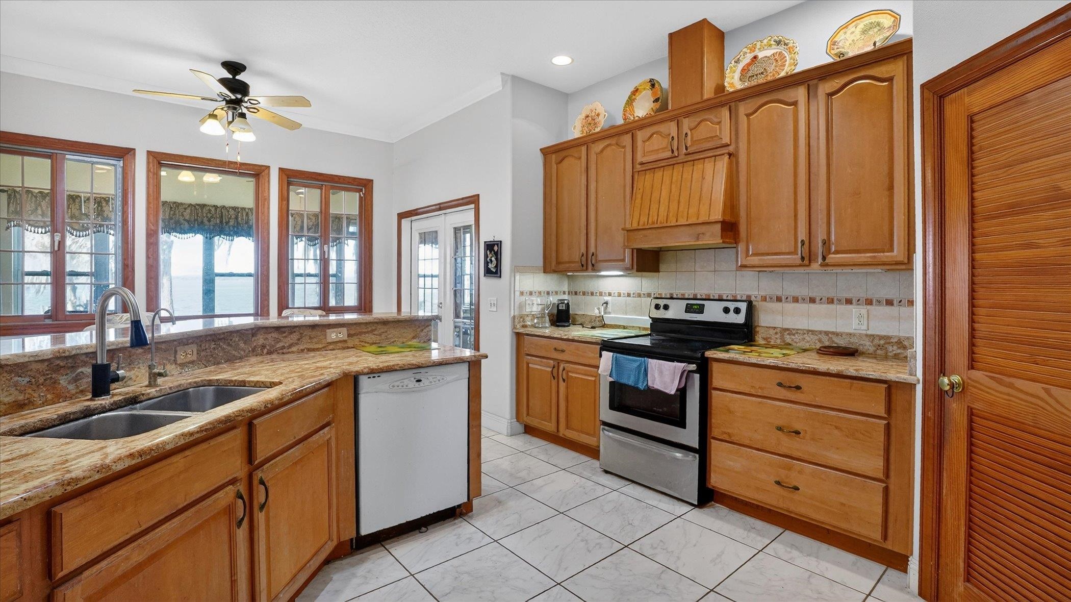 453 Federal Point Road East Palatka, FL 32131 - Photo 19 of 68 a kitchen with granite countertop a sink stainless steel appliances and cabinets