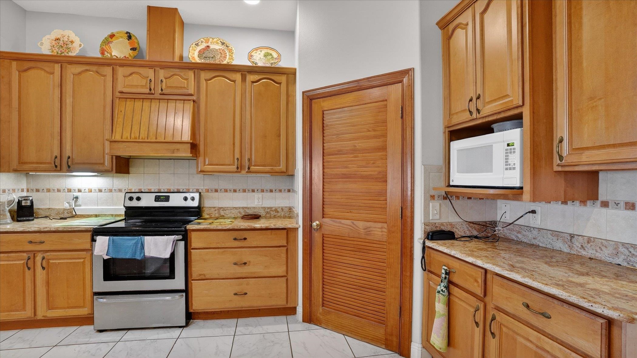 453 Federal Point Road East Palatka, FL 32131 - Photo 20 of 68 a kitchen with granite countertop white cabinets stainless steel appliances and a sink