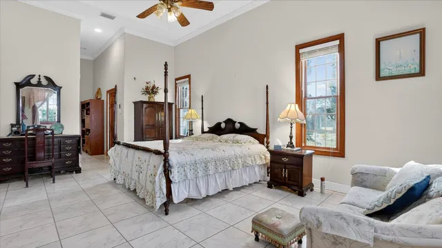 a bedroom with a bed and a painting on the wall