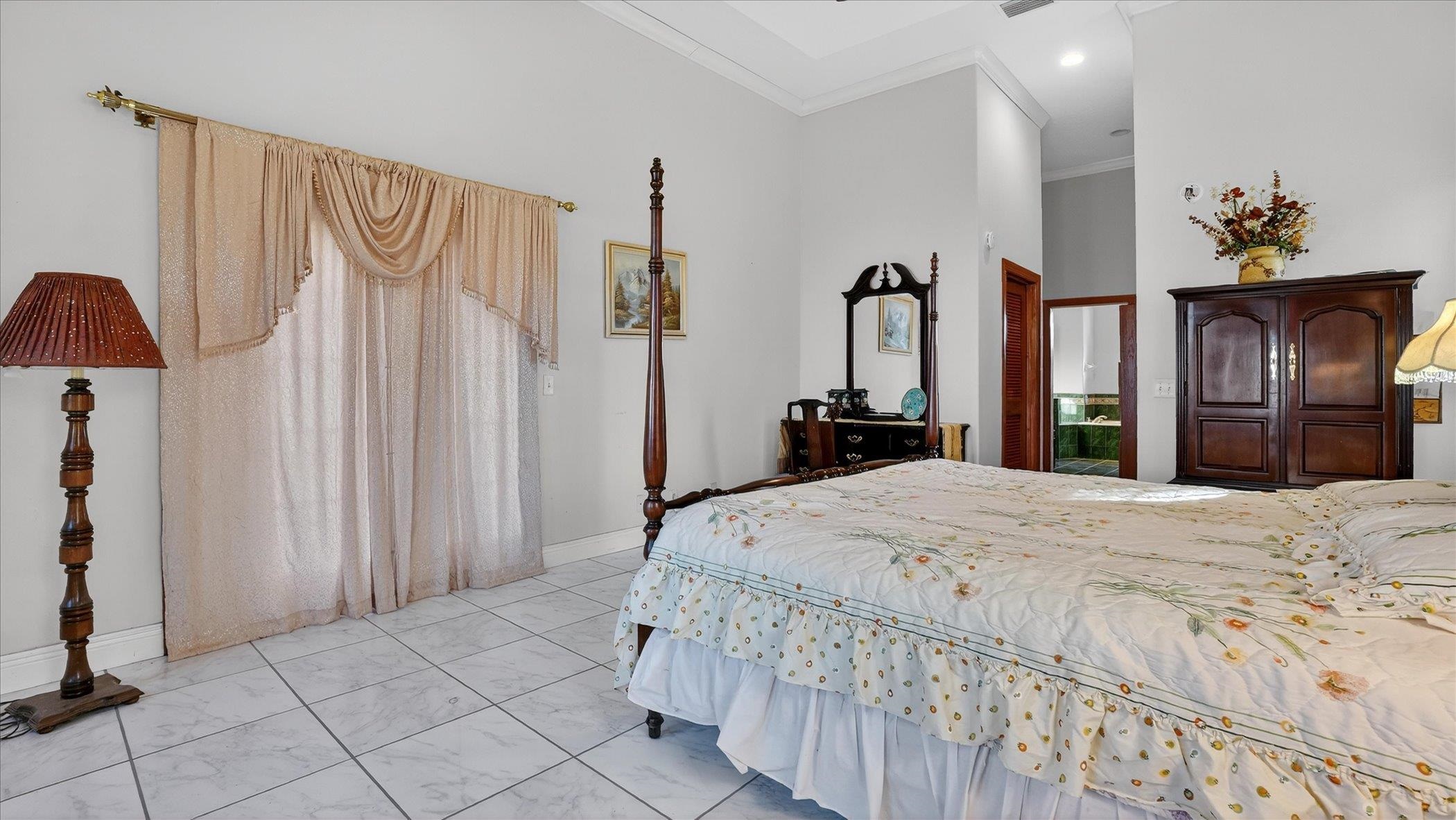 453 Federal Point Road East Palatka, FL 32131 - Photo 29 of 68 a bedroom with a bed and a large mirror