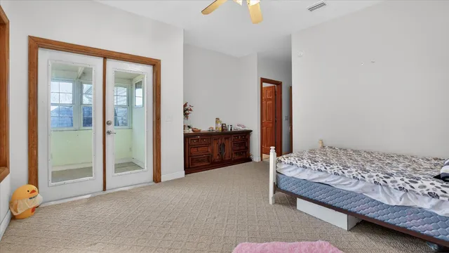 a living room with furniture and floor to ceiling window