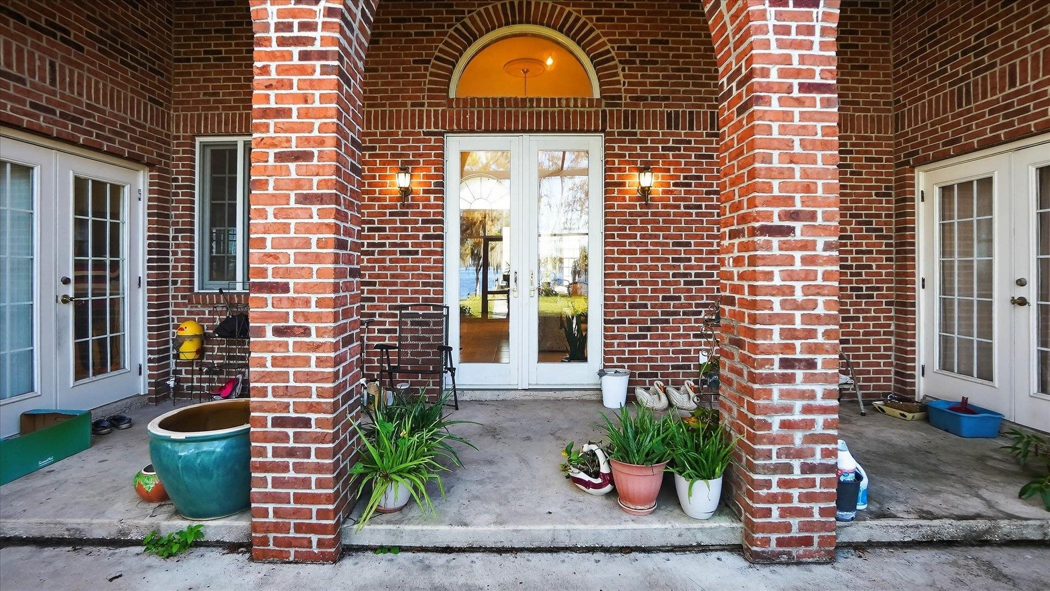 453 Federal Point Road East Palatka, FL 32131 - Photo 48 of 68 Doorway to property with french doors, brick siding, and covered porch