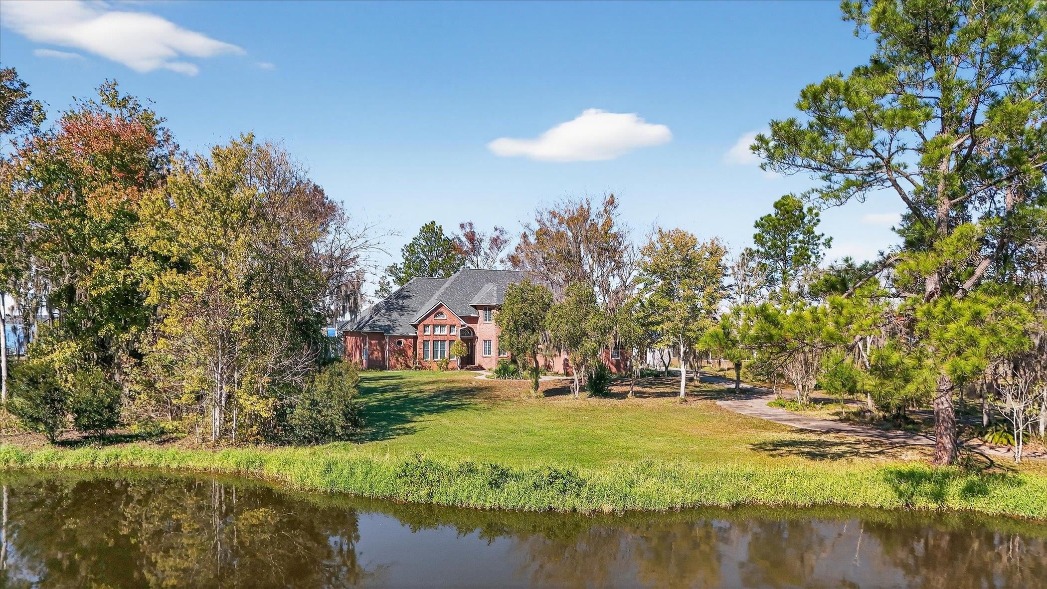 453 Federal Point Road East Palatka, FL 32131 - Photo 65 of 68 Rear view of property featuring a yard and a water view