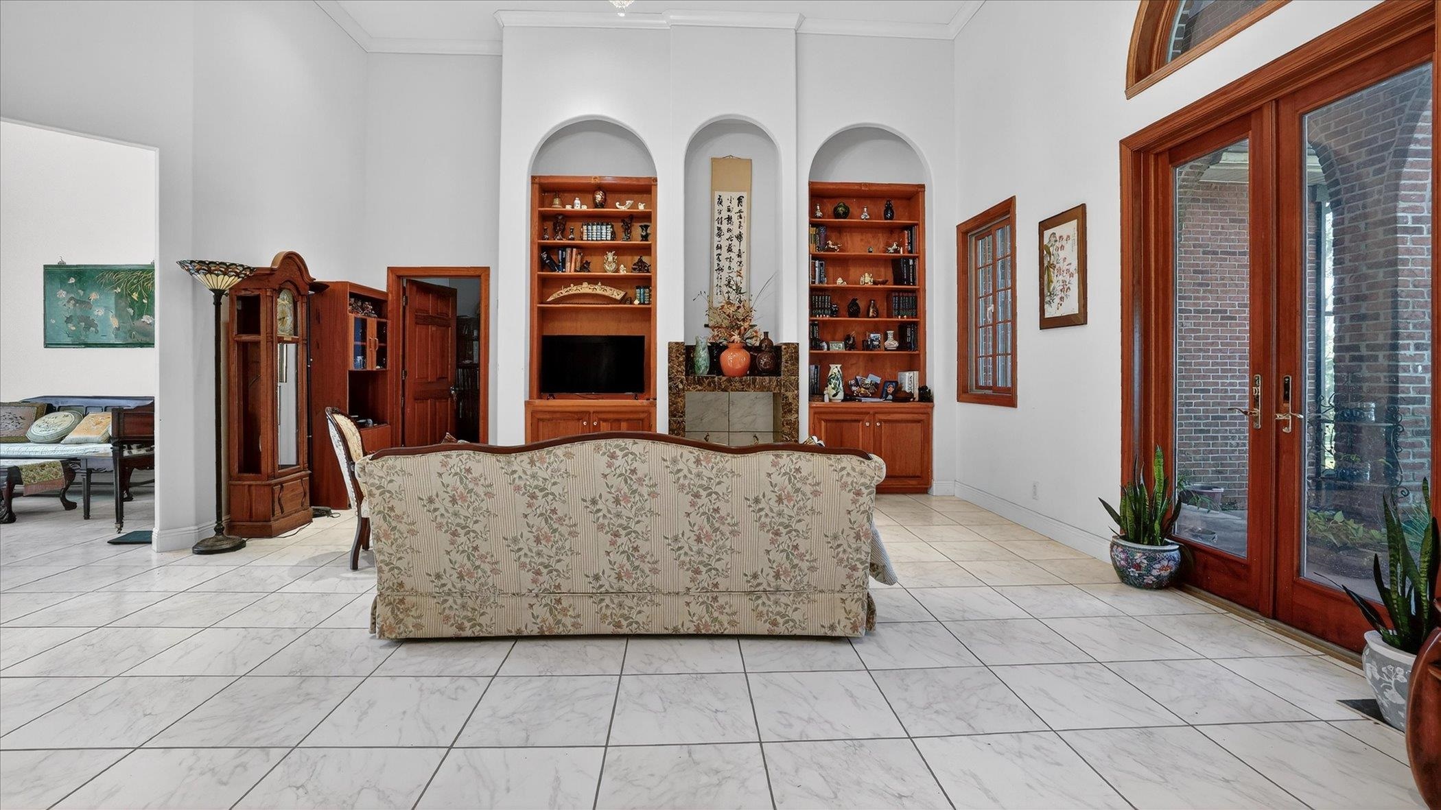 453 Federal Point Road East Palatka, FL 32131 - Photo 9 of 68 Dining area with french doors, built in features, a towering ceiling, crown molding, and healthy amount of natural light