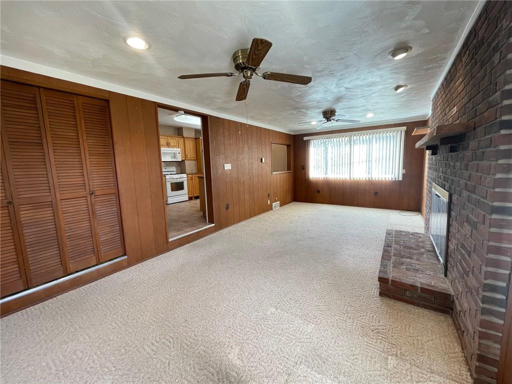 405 Routh Street Monroeville, PA 15146 - Photo 6 of 18 a view of an empty room with a fireplace and a window