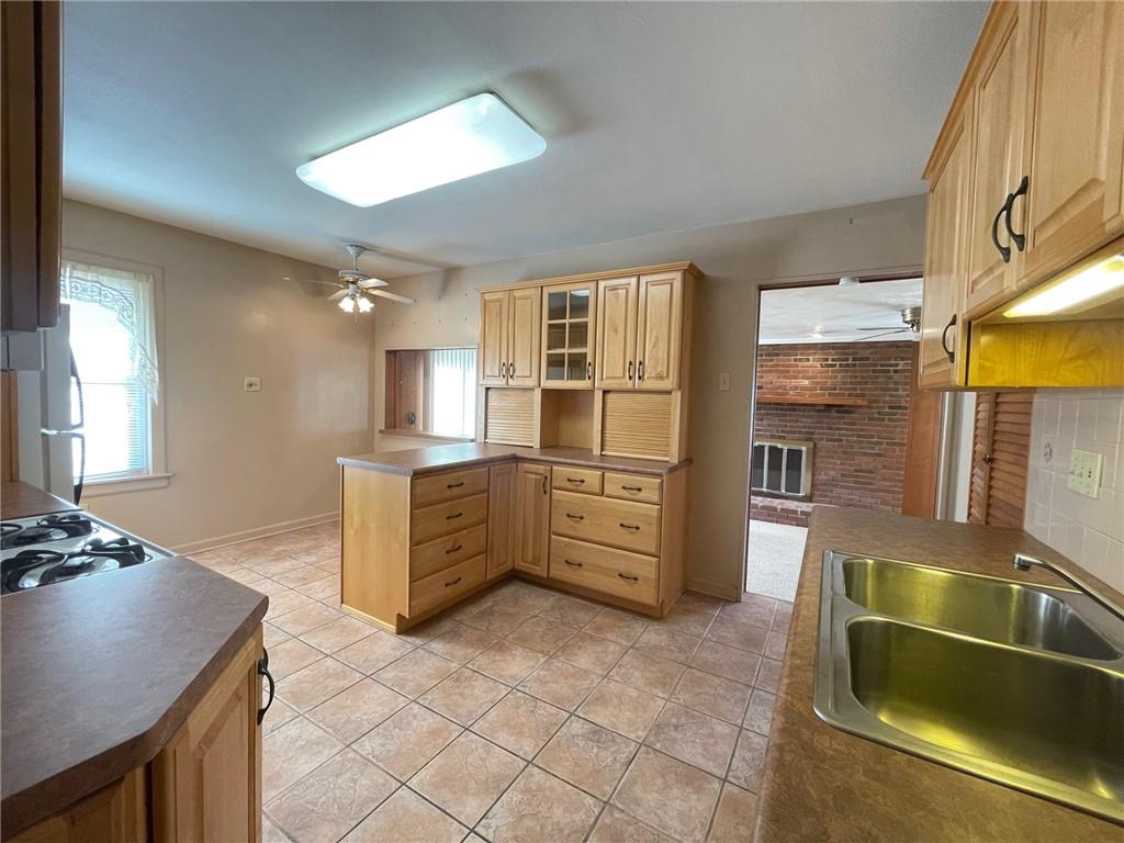 405 Routh Street Monroeville, PA 15146 - Photo 8 of 18 a large kitchen with kitchen island a large window and stainless steel appliances