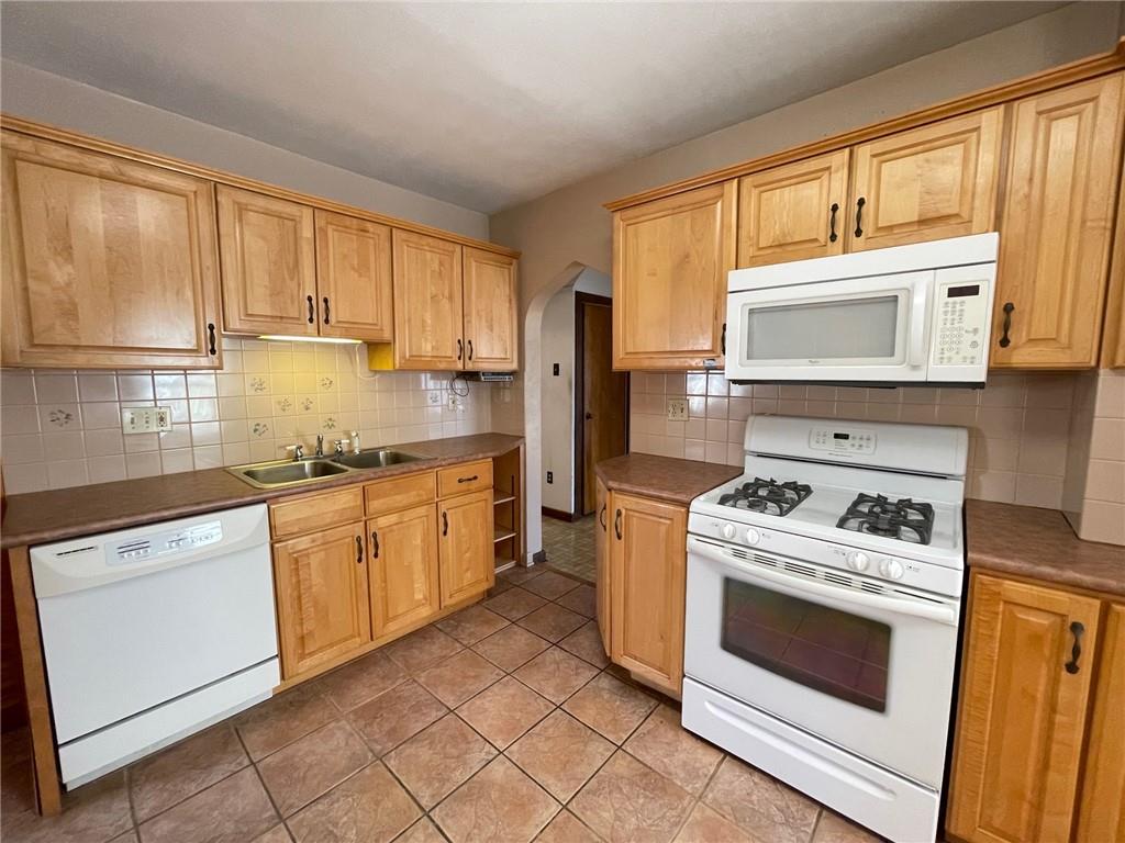405 Routh Street Monroeville, PA 15146 - Photo 10 of 18 a kitchen with granite countertop cabinets stainless steel appliances and a sink