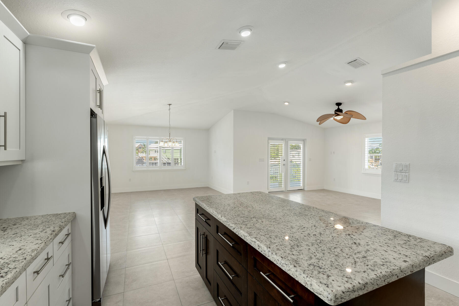 955 Plantation Road Key Largo, FL 33037 - Photo 16 of 37 a kitchen with granite countertop cabinets and chandelier