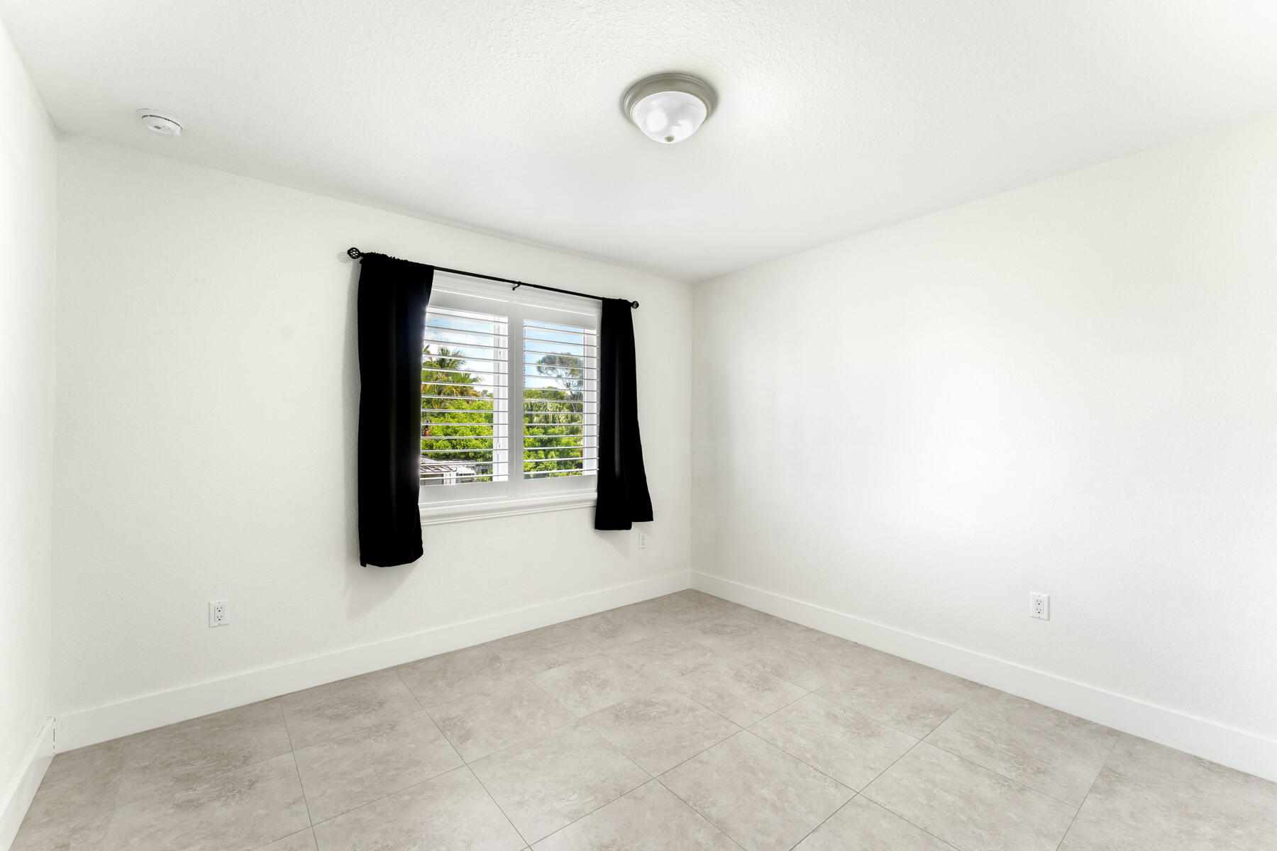 955 Plantation Road Key Largo, FL 33037 - Photo 18 of 37 a view of an empty room with a window