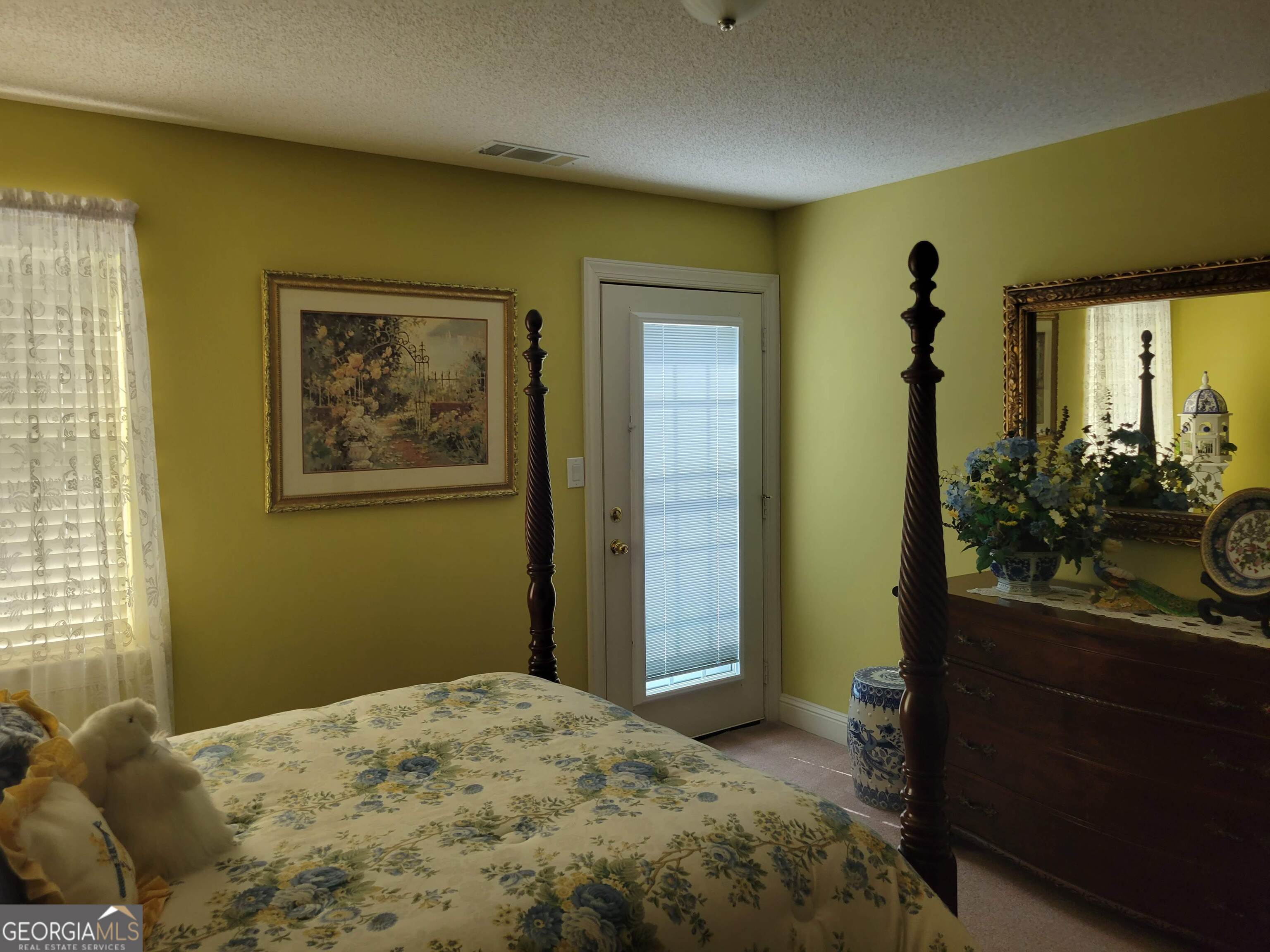 5325 Bethlehem Road Fairburn, GA 30213 - Photo 18 of 21 a bedroom with a bed and a mirror