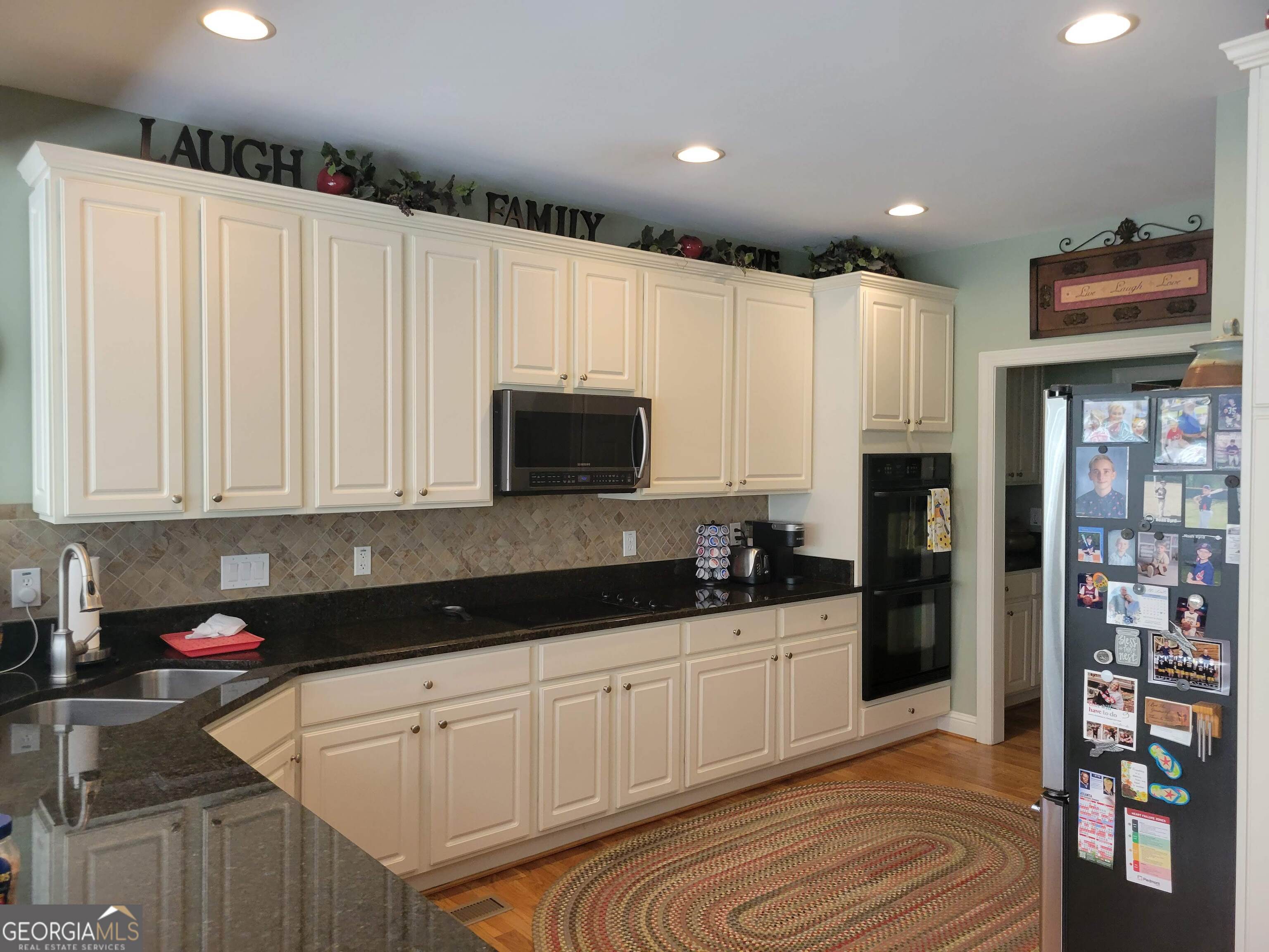 5325 Bethlehem Road Fairburn, GA 30213 - Photo 10 of 21 a kitchen with granite countertop white cabinets and stainless steel appliances