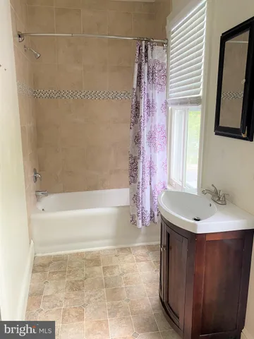 a bath room with a sink and a bath tub