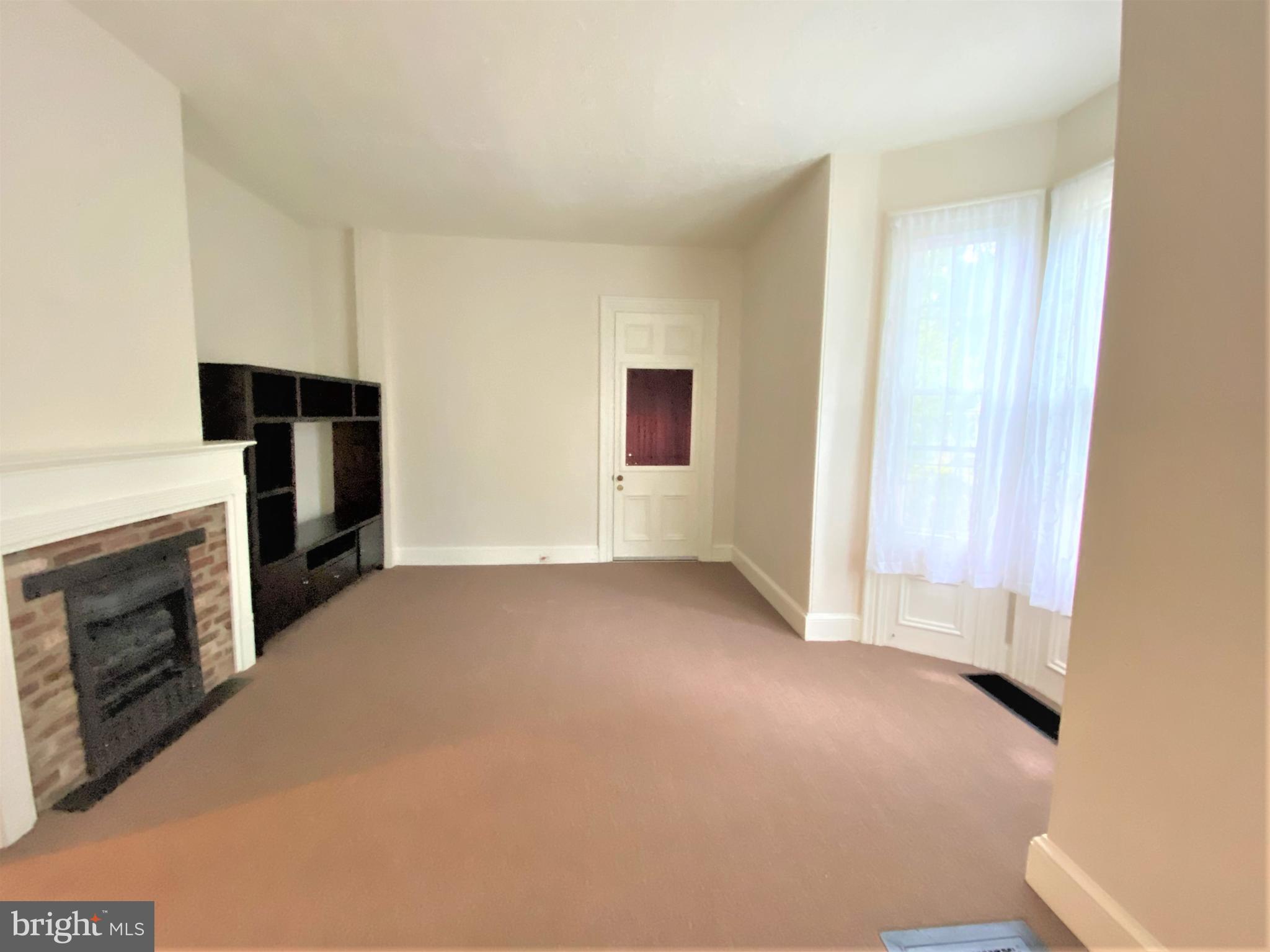 200 Broad Street Mount Holly, NJ 08060 - Photo 6 of 19 a view of an empty room with a fireplace and a window