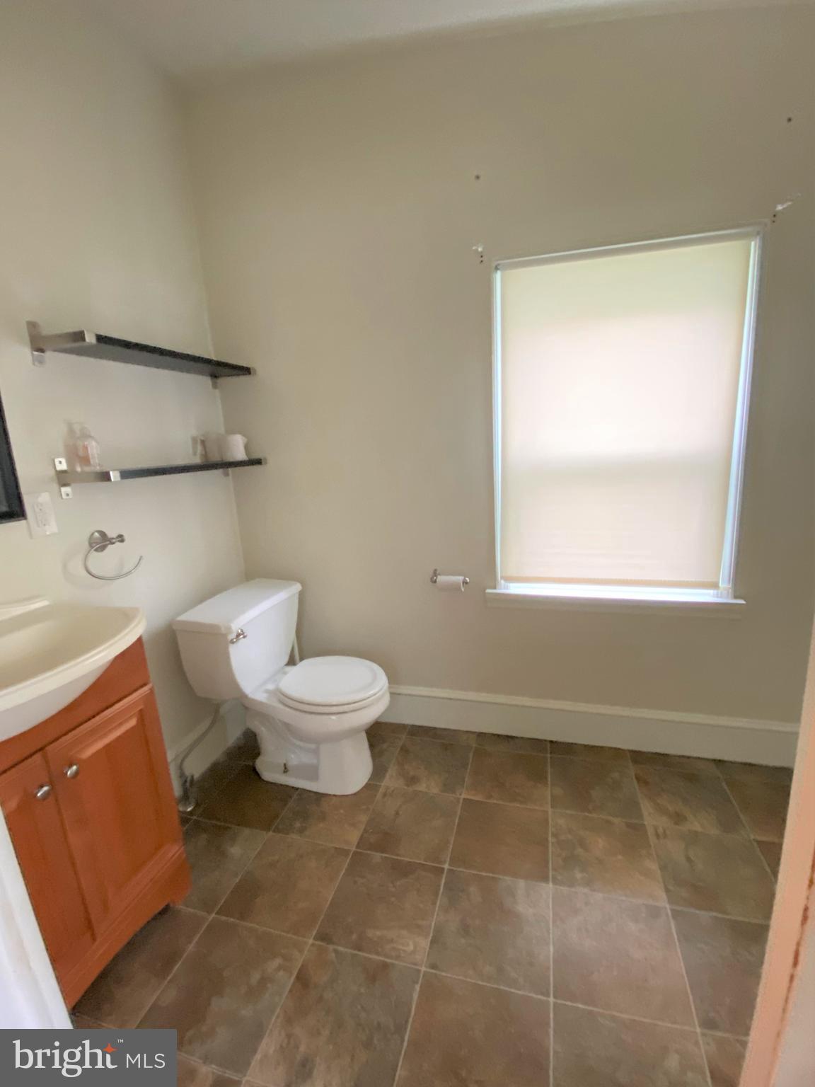 200 Broad Street Mount Holly, NJ 08060 - Photo 10 of 19 a bathroom with a toilet a sink and a mirror