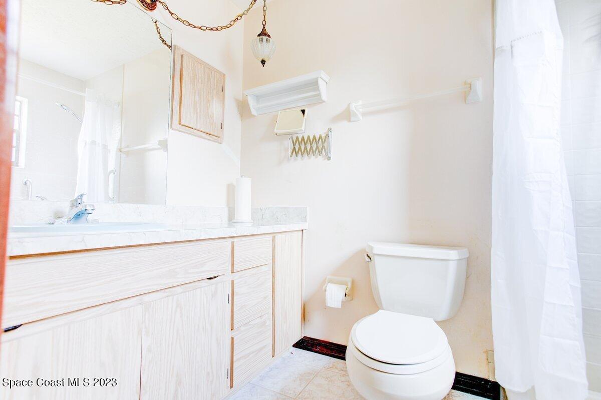 2160 Stewart Road Melbourne, FL 32935 - Photo 11 of 18 a white toilet sitting next to a bathroom sink