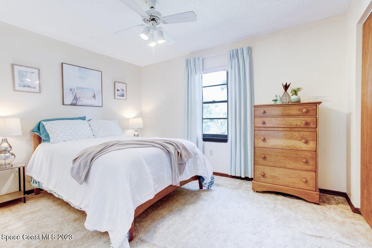 2160 Stewart Road Melbourne, FL 32935 - Photo 5 of 18 a spacious bedroom with a bed and a window