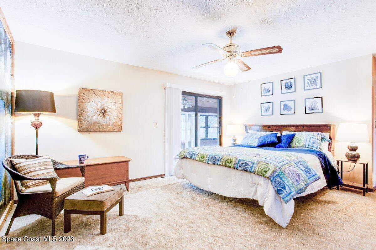 2160 Stewart Road Melbourne, FL 32935 - Photo 8 of 18 a bedroom with a bed and a chandelier