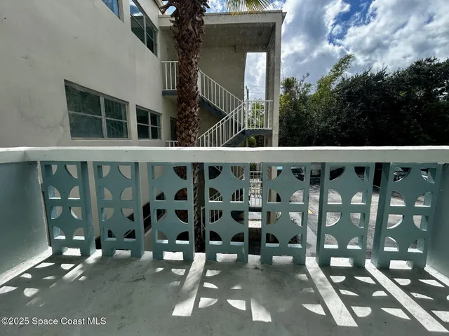 a view of a chair and table in the balcony