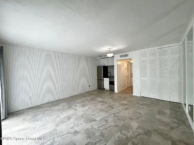 a kitchen with stainless steel appliances a refrigerator and a stove